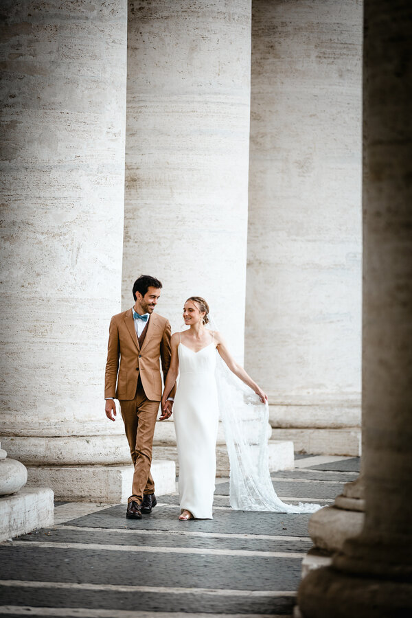 Newly-weds Sposi Novelli strolling under St. Peter's Square Colonnade