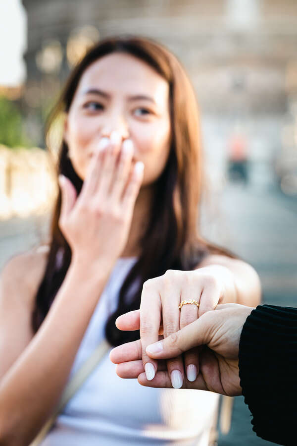 Fiancée holding out her hand showing off her engagement ring in Rome
