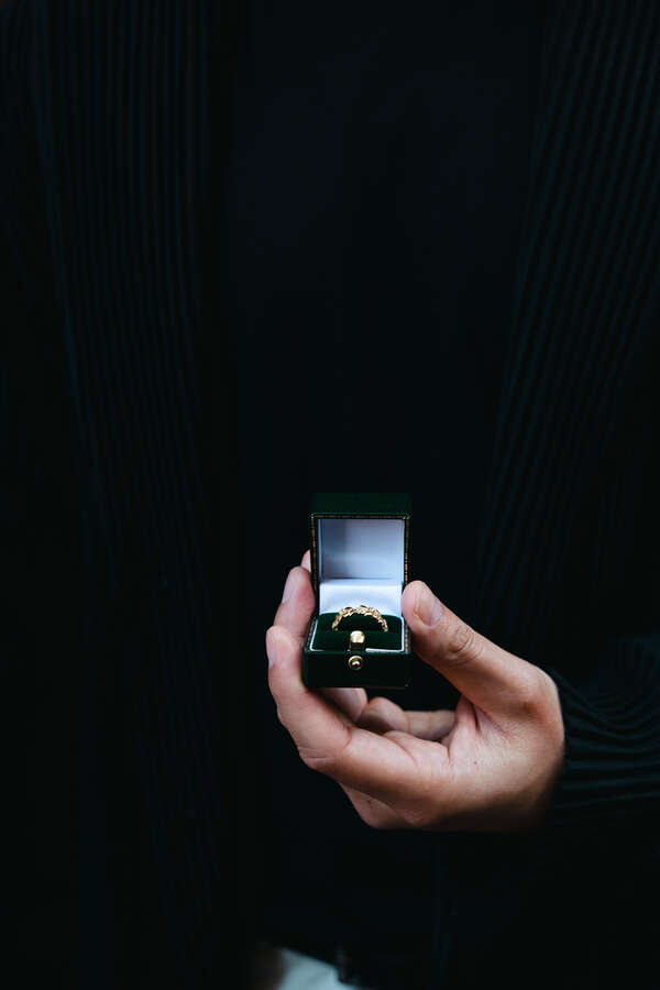 Guy holding the engagement ring box during his marriage proposal photoshoot in Rome