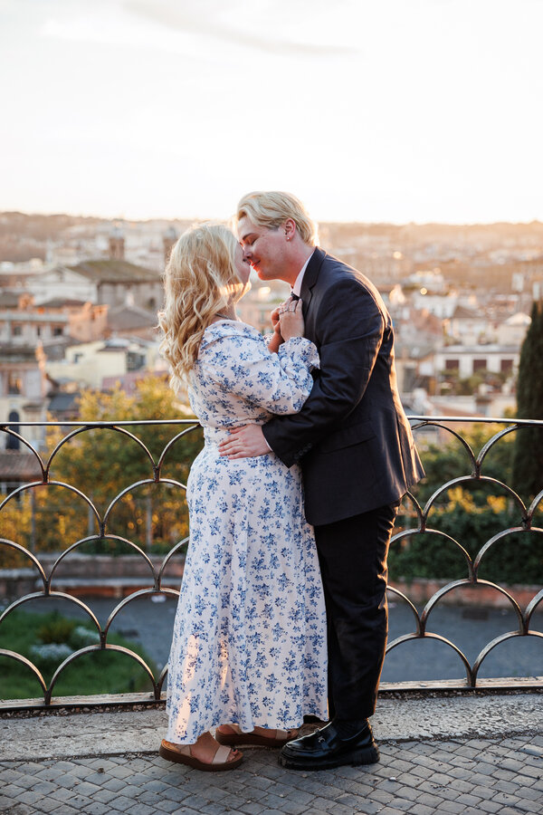Newly-engaged couple kissing each other during their surprise proposal photoshoot in Rome