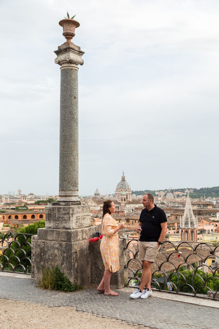 Newly-engaged couple enjoying a moment of relax after a surprise proposal at the Pincio Garden in Rome