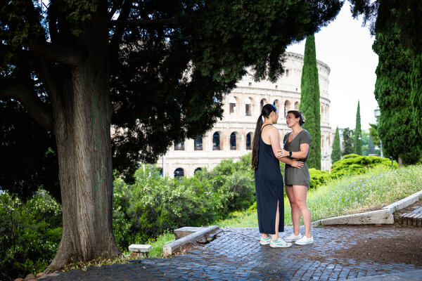 Same-sex couple moments before their surprise wedding proposal on Monte Oppio by the Colosseum