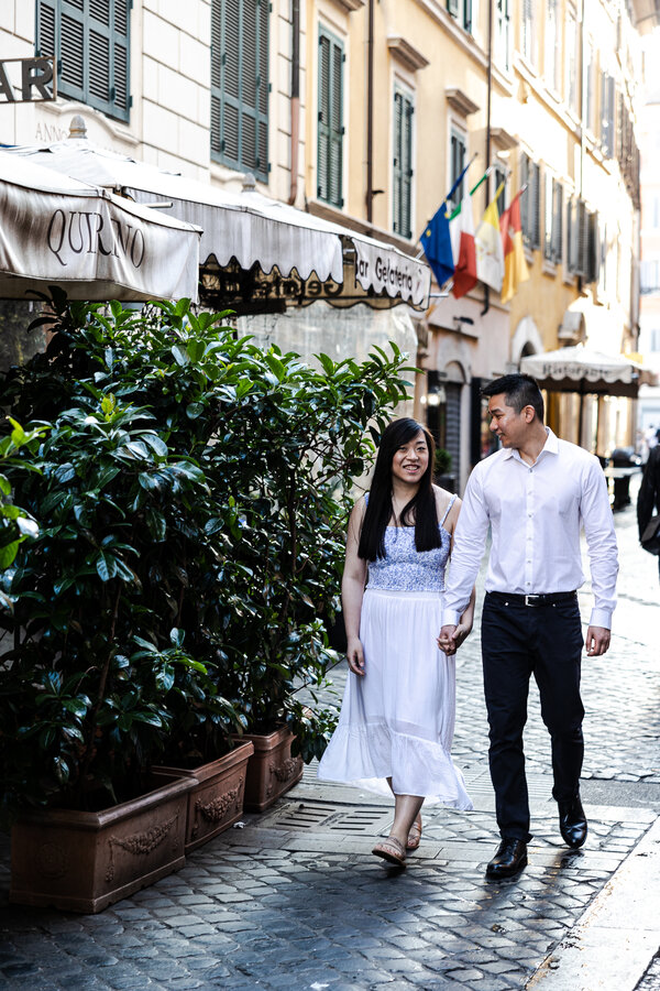 Newly-engaged couple strolling in Rome after their surprise proposal at the Trevi Fountain