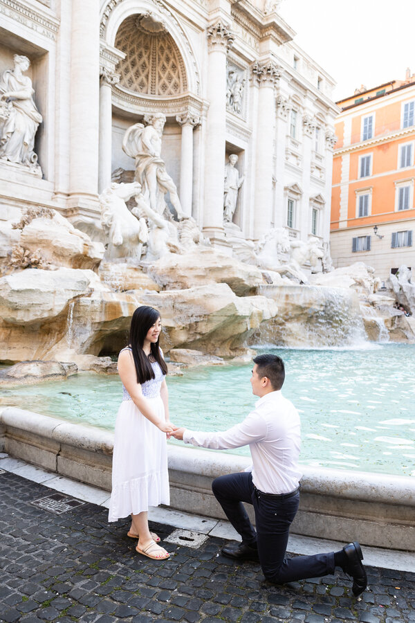 Surprise wedding proposal at the Trevi Fountain in the early morning in Rome