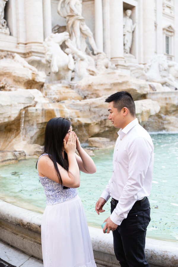 Emotional moment during a surprise wedding proposal at the Trevi Fountain in Rome