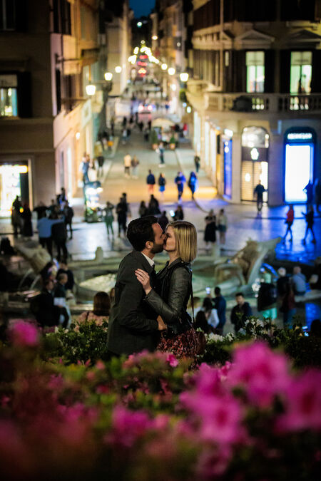 Newly-engaged couple kissing on the Spanish Steps during their proposal photo session in Rome