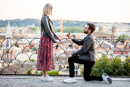 Beautiful surprise proposal on the Terrazza Belvedere at sunset, in Rome