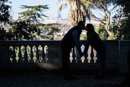 Couple in silhouette kissing in the Pincio Gardens, during their Secret Proposal Photo shoot