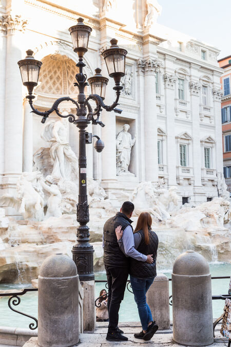 Couple enjoying the view of the majestic Trevi Fountain