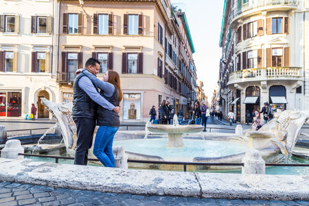 Couple in love at the Barcaccia Fountain in Piazza di Spagna