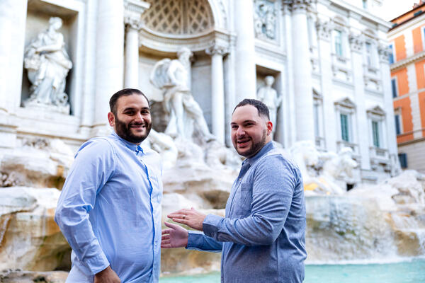 Newly-engaged couple after their surprise proposal at the Trevi Fountain Rome