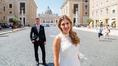 Bride and Groom posing along Via della Conciliazione for their wedding photo shoot in Rome