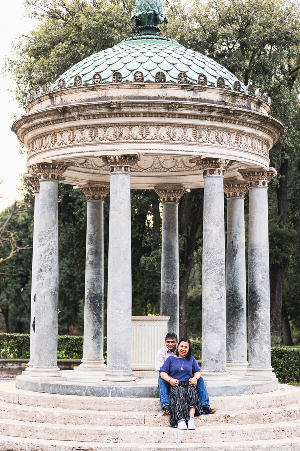Couple sitting at the Temple of Diana in Villa Borghese in Rome