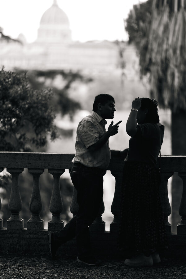 Black and white image of a couple at the Pincio Gardens in Rome with the Vatican in the background