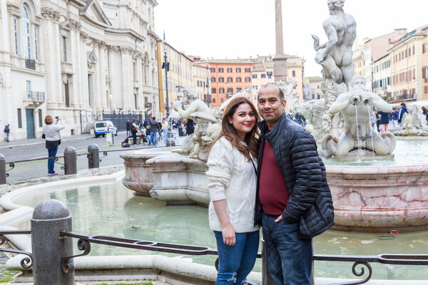 Happy smiles of husband and wife on Sant'Angelo Bridge, Rome