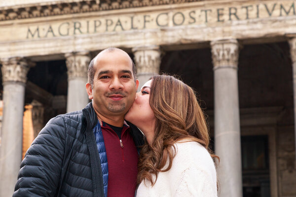 Wife kissing fondly her husband in family photo shoot in Rome