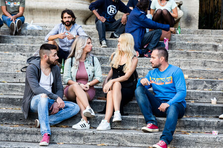 Friends relaxing on stairs in Piazza Trilussa in Trastevere