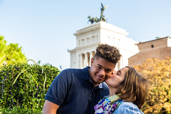 Mother kissing son at the Capitoline Hill during a family photo shoot in Rome