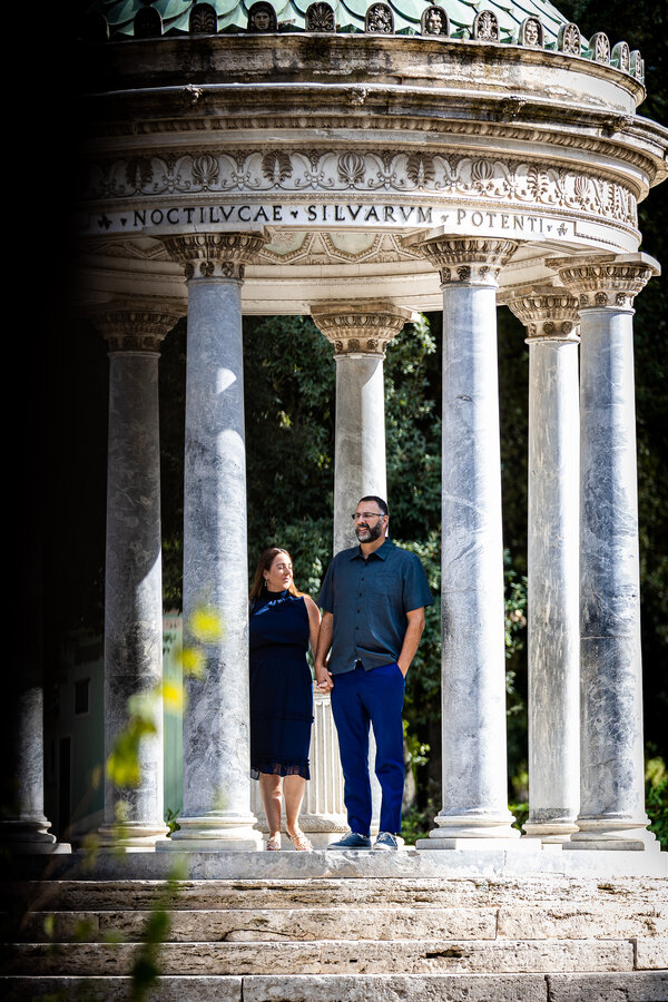 Couple standing under the Temple of Diana in Villa Borghese
