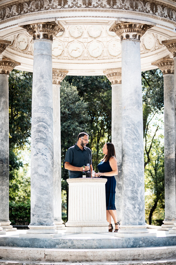 Lovely couple celebrating their 15th wedding anniversary in Rome under the Temple of Diana in Villa Borghese