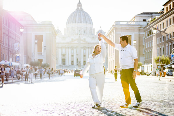 Couple dancing with the Vatican in the background during their wedding anniversary photo shoot in Via della Conciliazione in Rome