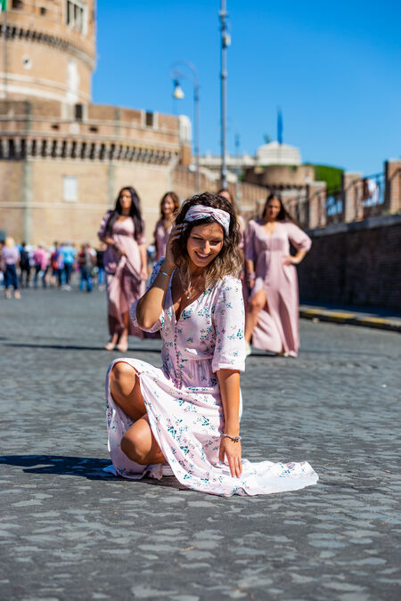Bride in the foreground and bridesmaids in the background during a bachelorette photo shoot at Castel Sant'Angelo Rome