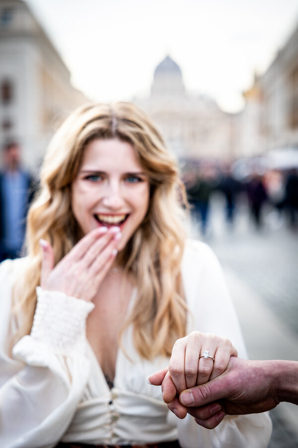 Lovely girl showing off her engagement ring with the Vatican in the background
