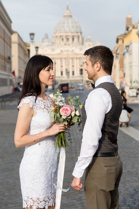 Wedding couple standing in the main entrance of Castel Sant'Angelo during a romantic wedding photo shoot