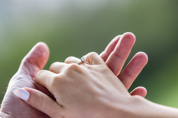 Engagement ring while holding hands during a surprise propsoal photo shoot in Rome