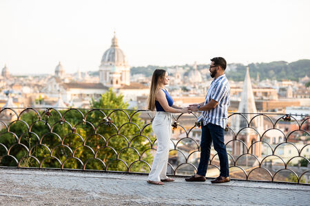 Couple during their surprise proposal on the Pincio Terrazza Belvedere at sunset