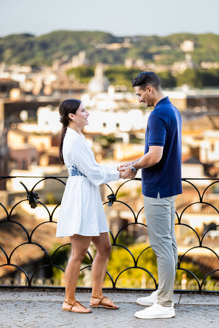 Couple holding hands on the Terrazza Belvedere moments before their surprise marriage proposal in Rome