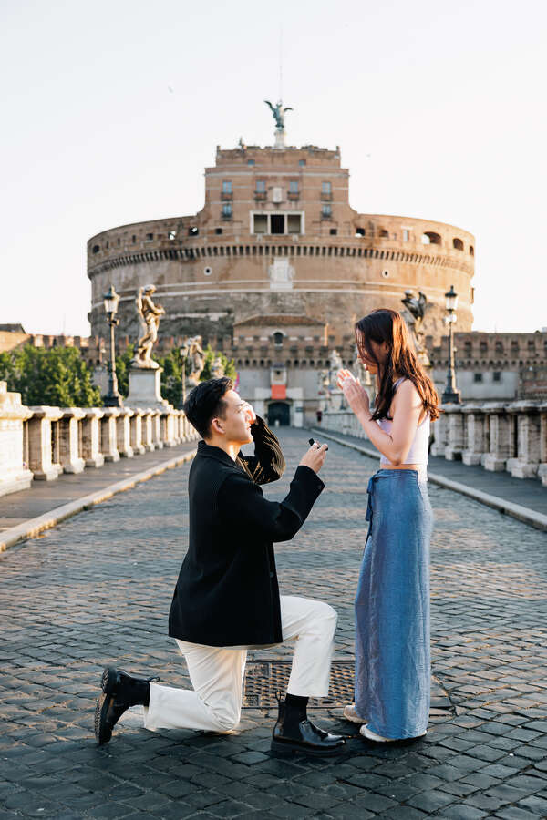 Surprise wedding proposal in Rome on Castel Sant'Angelo Bridge in the early morning