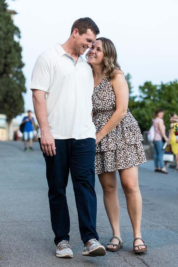 Happy couple strolling during their surprise proposal photo shoot on the Pincian Hill in Rome