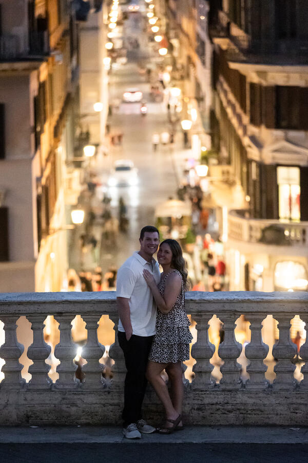 Happy newly-engaged couple on the Spanish Steps after sunset