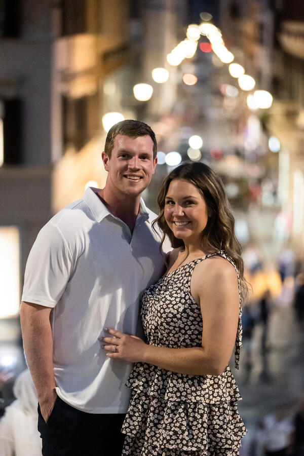 Happy couple on the Spanish Steps during their surprise proposal photo session in Rome