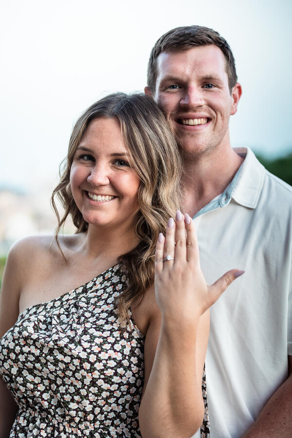 Fiancée showing off her engagement ring while posing during their surprise proposal photo shoot on the Terrazza Belvedere in Rome