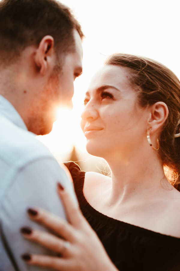 Newly engaged couple at sunset gazing in other's eyes during their proposal photo session at the Pincio Gardens in Rome