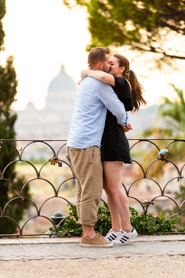 Couple kissing during their proposal photo session at the Pincio Garden