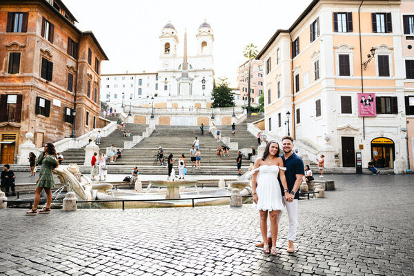 Newly-engaged couple in Piazza di Spagna during their engagement photo session after their surprise proposal shoot in Rome