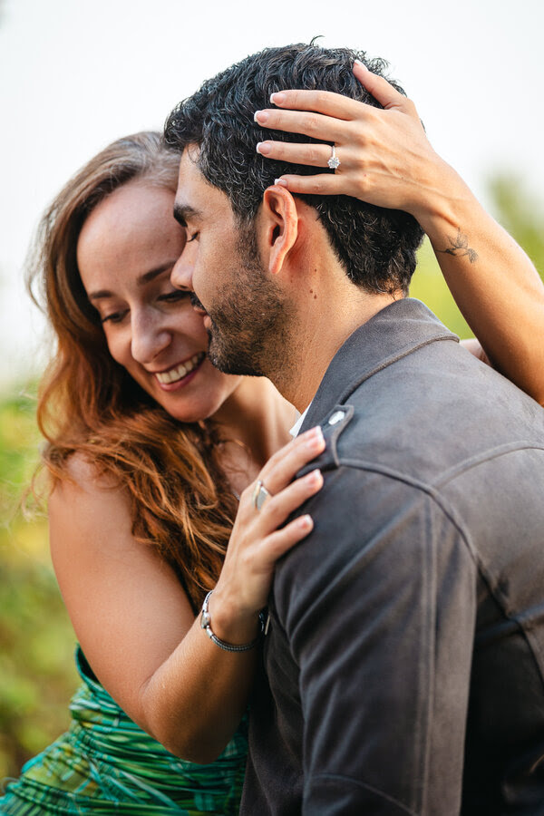 Portrait of newly-engaged couple being romantically close to each other during their marriage proposal photoshoot in Rome