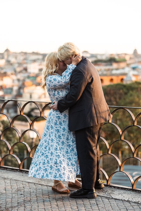 Newly-engaged couple kissing on the Terrazza Belvedere at sunset