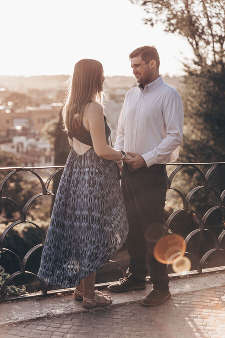 Couple on the Terrazza Belvedere at sunset during their marriage proposal 
