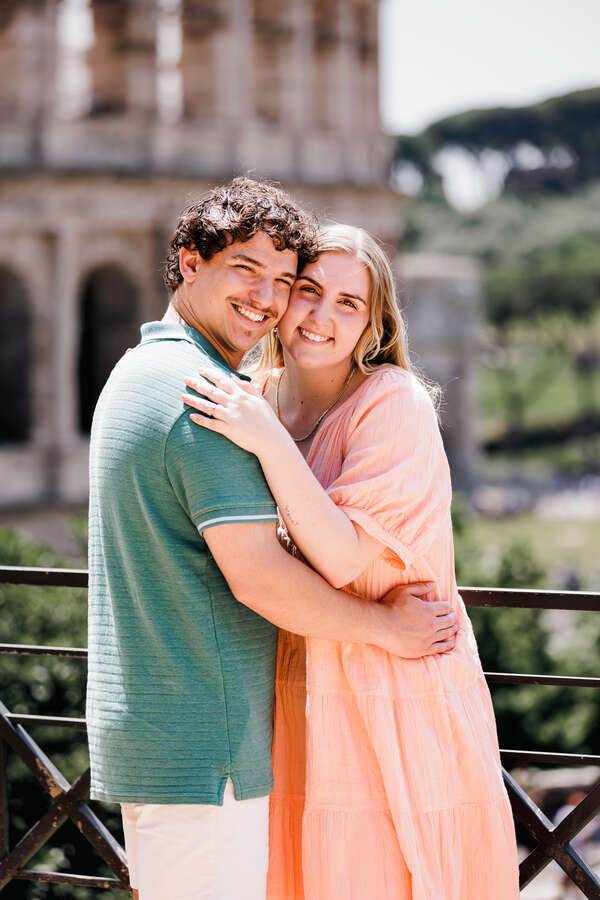 Newly-engaged couple on the Giardinetto del Monte Oppio overlooking the Colosseum in Rome