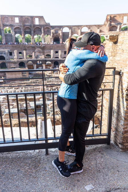 Newly-engaged couple during a tender moment at the Colosseum