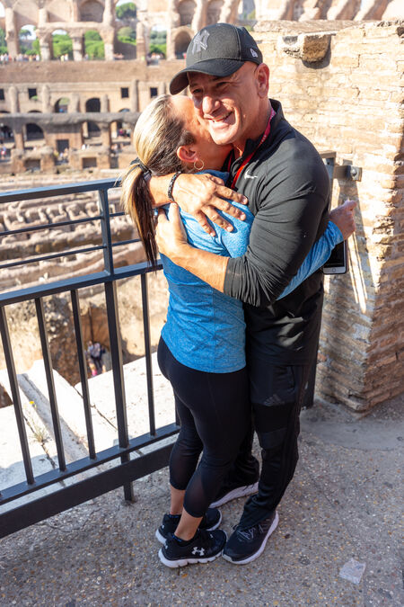 Couple joyously smiling celebrating their engagement at the Colosseum in Rome