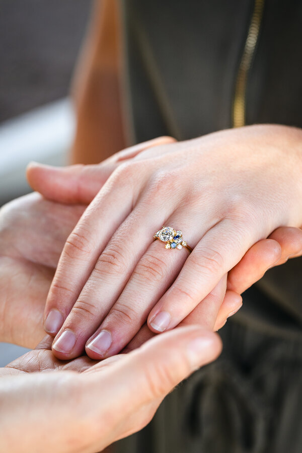 Hand with a beautiful engagement ring on, during a surprise wedding proposal in Rome