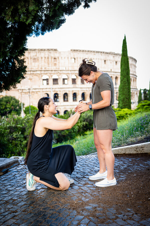 Romantic same-sex surprise marriage proposal on Monte Oppio with the Colosseum in the background in Rome