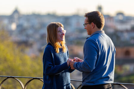Couple holding hands at the Pincio Belvedere during their surprise proposal in Rome