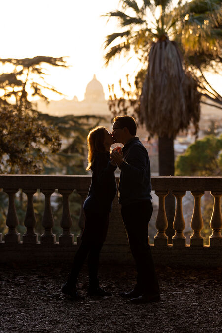 Couple kissing during their engagement photo session at the Pincio Gardens in Rome