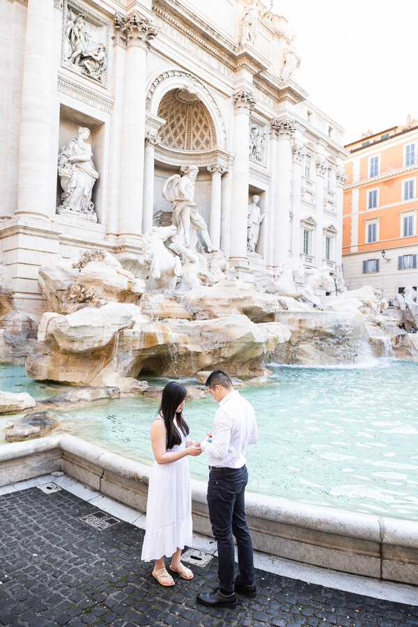 Couple during their marriage proposal at the Trevi Fountain in Rome